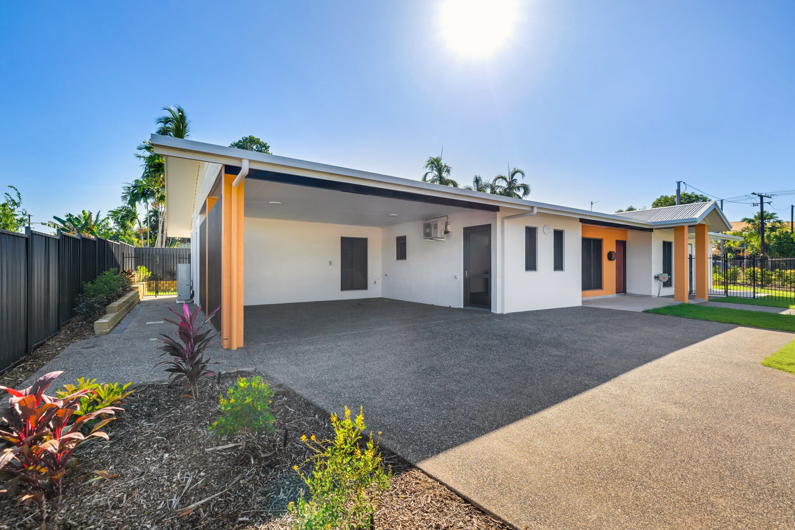 SDA home front exterior, highlighting the car port and front entrance